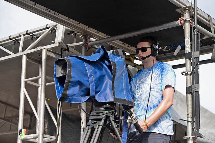 MTSU junior Houston Chapman, a video and film production major from Nolensville, Tenn., films a performance on the Who stage Sunday, June 19, at the Bonnaroo Music and Arts Festival in Manchester, Tenn. MTSU returned to the festival this year as part of its ongoing partnership with the event to provide College of Media and Entertainment students with real-world experience. (MTSU photo by James Cessna)