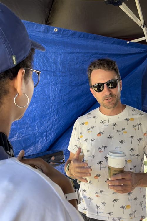 Middle Tennessee News journalist Lily Manyara, left, a junior in music business from Richmond, Va., interviews Emmy-winning producer Tom Steel on Sunday, June 19, about his experience working with MTSU College of Media and Entertainment students to provide streaming of performances for Hulu during this year’s Bonnaroo Music and Arts Festival in Manchester, Tenn. (MTSU photo by Rebekah McGuire)