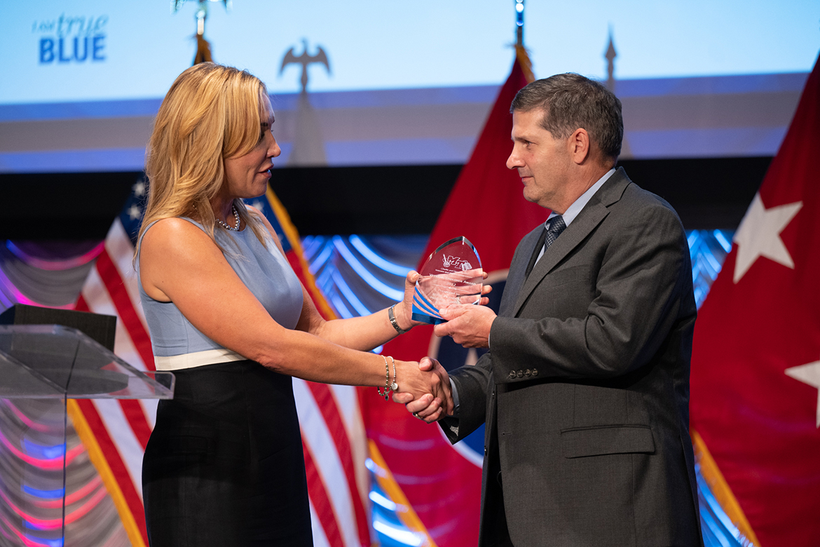 Middle Tennessee State University Daniels Center Director Hilary Miller, left, presents the inaugural Veteran Employer Award to Jimmy Hiller of Nashville, Tenn., owner of title sponsor Hiller Plumbing, Heating, Cooling and Electrical, in August 2022 during the fifth annual Veteran Impact Celebration in the MTSU Student Union Ballroom. Nearly 250 people attended the fundraiser for the Charlie and Hazel Daniels Veterans and Military Family Center. (MTSU file photo by James Cessna)
