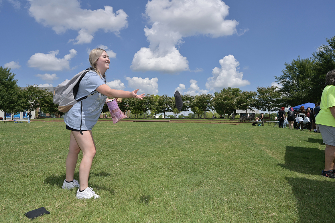 Sophia Dorning, 21, a senior business management major from Lawrenceburg, Tenn., tosses a beanbag while playing cornhole and trying to win a prize during Meet Murfreesboro Tuesday, Aug. 23, in the at the Domino’s Pizza tent in Student Union Commons. MTSU students will have another opportunity to attend the annual event from 10 a.m. to 2 p.m. Wednesday, Aug. 24. Meet Murfreesboro will continue from 10 a.m. to 2 p.m. Wednesday, Aug. 24. (MTSU photo by Andy Heidt)