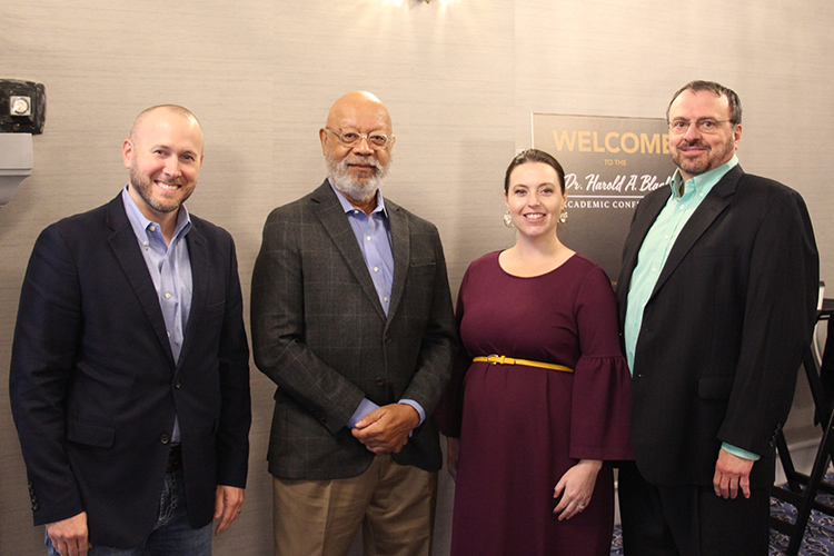 Harold Black, second from left, emeritus professor of finance at the University of Tennessee, Knoxville, was honored by conference organizers, from left, MTSU economics professor Daniel J. Smith, Claudia Williamson Kramer from the University of Tennessee, Chattanooga, and Ramon DeGennaro from the University of Tennessee, Knoxville, at the Read House in Chattanooga, Tenn., on Sept. 10, 2022.   (MTSU photo by Brian Delaney)