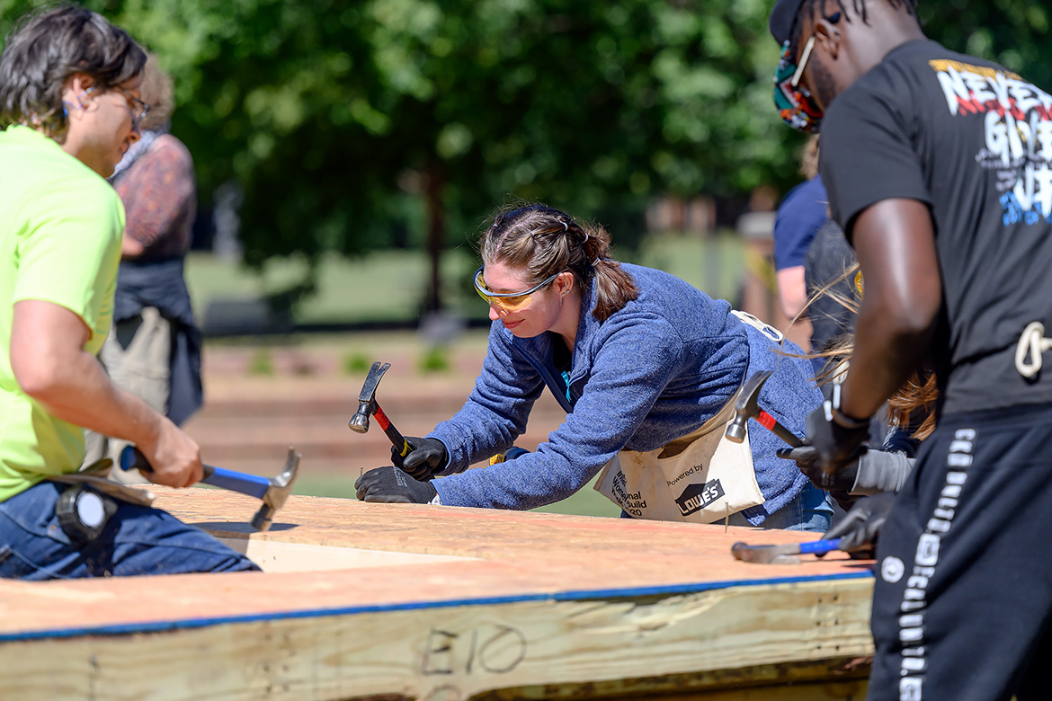 MTSU alumna Lili Vaught, right, with event sponsor Exit Realty/Bob Lamb, hammers nails with other volunteers Thursday, Sept. 29, during the Habitat for Humanity panel build in the Student Union Commons. Volunteers included MTSU students. (MTSU photo by J. Intintoli)