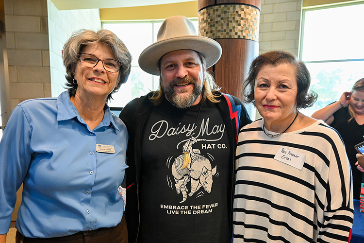 Middle Tennessee State University College of Education faculty Connie Casha, left, and Pam Ertel, right, welcome Zac Brown Band guitarist and early childhood education advocate Coy Bowles, center, to campus as the keynote speaker for the college’s annual Play Symposium event on Oct. 1, 2022. (MTSU photo by Stephanie Wagner)