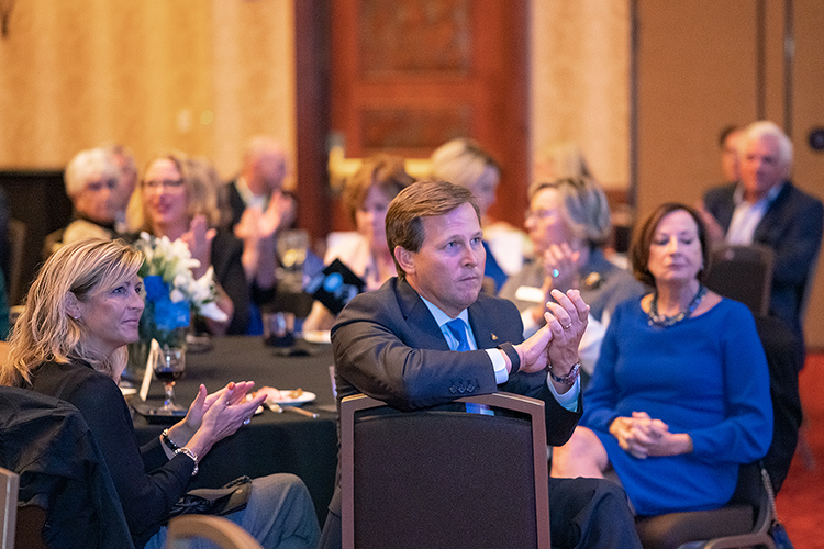 Middle Tennessee State University alumnus Jeff Ballard, president of Delta Dental of Tennessee, center, claps during a special reception for 2022 Leadership Summit award recipients hosted by the Jennings A. Jones College of Business on Oct. 27, 2022, at Embassy Suites in Murfreesboro, Tenn. Ballard was presented the Jones College Exemplar Award. (MTSU photo by Cat Curtis Murphy)
