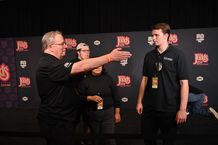Bob Gordon, Middle Tennessee State University media arts professor, left, directs MTSU students and alumni as producer of the MTSU red-carpet broadcast for “The Judds: Love is Alive – The Final Concert” event on Thursday, Nov. 3, 2022, at the Murphy Center on campus. (MTSU photo by James Cessna and Cat Curtis Murphy)