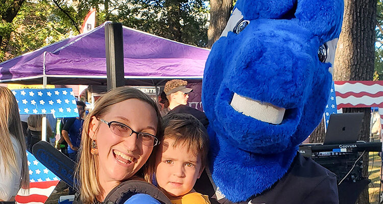 Aiko Baker, Middle Tennessee State University education student, left, balances parenting her son, Avery Baker, center, with her studies and part-time job with help from MTSU’s child care grant, which the university’s June Anderson Center awards to around 20 families each semester. Baker and her son recently grabbed a photo with mascot Lightning while attending the campus’ first home football game in fall 2022. (Photo courtesy of Aiko Baker)