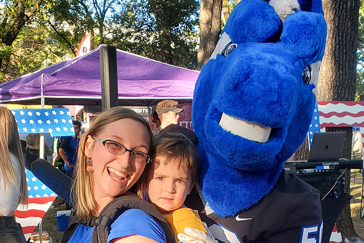 Aiko Baker, Middle Tennessee State University education student, left, balances parenting her son, Avery Baker, center, with her studies and part-time job with help from MTSU’s child care grant, which the university’s June Anderson Center awards to around 20 families each semester. Baker and her son recently grabbed a photo with mascot Lightning while attending the campus’ first home football game in fall 2022. (Photo courtesy of Aiko Baker)