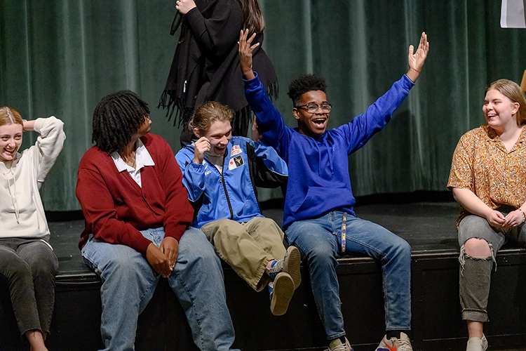 Siegel High School Humanities Academy students react as Tennessee Performing Arts Center visiting artist/educator Alison Brazil, on stage in background, leads them to compose an original song Jan. 25 during Humanities Week at the Murfreesboro, Tenn., high school. The academy is a partnership between Siegel and Middle Tennessee State University’s College of Liberal Arts. (MTSU photo by J. Intintoli)