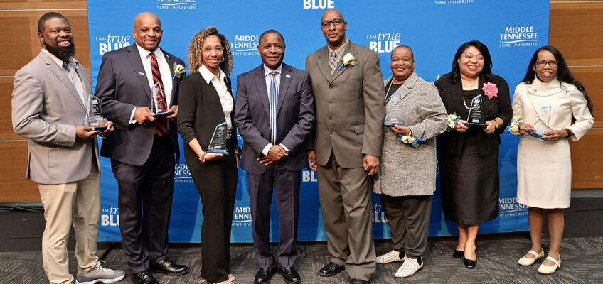 Middle Tennessee State University President Sidney A. McPhee, fourth from left, joined the university in honoring seven “unsung heroes” during the 27th annual Unity Luncheon held Wednesday, Feb. 8, at the Student Union Building. Pictured, from left, are honorees Christopher Rochelle; Michael McDonald; Stacy Windrow; McPhee; Joe and Sybil Rich; Vanessa Alderson; and Marva Lucas. (MTSU photo by Andy Heidt)
