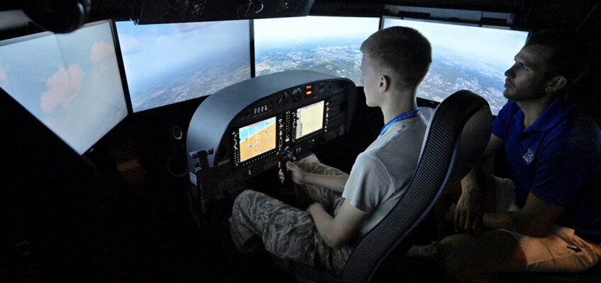 As certified flight instructor Trey Welch, right, looks on, a Civil Air Patrol cadet attending the weeklong National Cadet Engineering Technology Academy, also known as E-Tech, practices on a Department of Aerospace flight simulator Monday, July 10, at Murfreesboro Airport. Middle Tennessee State University again hosted the academy to expose the group of cadets from all over the country to a variety of science and engineering fields. (MTSU photo by Andy Heidt)