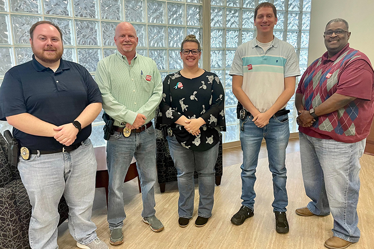 Middle Tennessee State University Police Detective Tommy Roberts, second from left, who specializes in investigating domestic violence and sexual assault, takes a photo April 26, 2023, with MTSU’s detective team on “Denim Day,” a campaign to raise awareness about the prevalence and misconceptions of sexual assault. Standing, from left, are Detective Trevor Chaney, Roberts, Detective Lt. Kim Rednour, Detective Lt. Andrew Bennet and Detective Derrick Wharton. (Submitted photo)