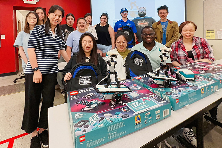 Middle Tennessee State University computer science students, along with MTSU faculty and graduate research assistants, take part in a summer enrichment program at the Kirksey Old Main Building on campus on June 29, 2023. Standing in back row, from left, are Xinyi Xia, Jiaying Shen, Jingyi Yang, Kaiqian Zhao, Xinyi Ren, Emily Musselman, Timothy Morren, Andrew Dale Becker and Lu Xiong, mathematical sciences assistant professor. Standing in front row, from left, are Yi Gu, computer science associate professor and program coordinator, Haiting Cai, Xingyu Chen, Kosy Okafor and Christabel Obi-Nwosu. (MTSU photo courtesy of Yi Gu)