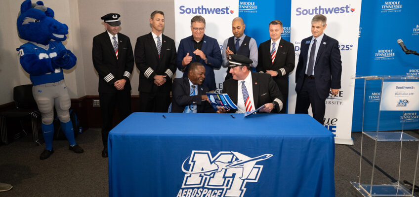 Middle Tennessee State University President Sidney A. McPhee, left, and Southwest Airlines Capt. Brad Monda shake hands after signing documents cementing the partnership as MTSU becomes part of the airline’s Destination 225° program Wednesday, Sept. 6, in the Business and Aerospace Building’s State Farm Lecture Hall. Acknowledging the agreement are back row, from left, MTSU mascot Lightning, Southwest Capts. Sean Strittmatter and Justin Peele, MTSU Provost Mark Byrnes and Aerospace Chair Chaminda Prelis. The program includes pathways for pilots who are just starting to fly, those working on university degrees and those already building time toward their Airline Travel Pilot certificate. (MTSU photo by James Cessna)