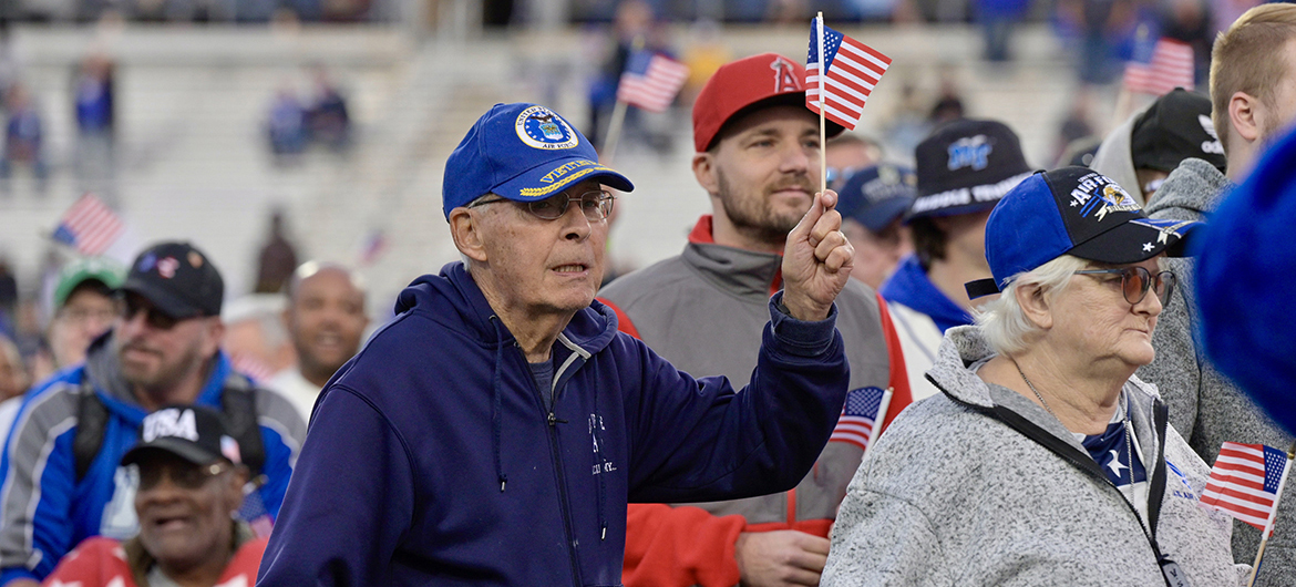 As the Band of Blue performs theme songs for the six military branches, a group of veterans go across Horace Jones Field in Floyd Stadium during special halftime ceremonies in November 2023 during the 41st annual Middle Tennessee State University Salute to Veterans and Armed Forces game. Veterans and active-duty personnel will be treated to special activities Saturday, Nov. 9, during the 42nd annual Salute to Veterans game in Floyd Stadium on the MTSU campus in Murfreesboro, Tenn. (MTSU file photo by Andy Heidt)