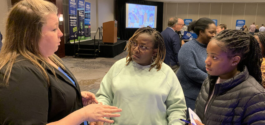 Becca Smitty, left, MT One Stop director at Middle Tennessee State University, reviews academic programs and options with mother and daughter Darice and Leah Townsend of Hazel Green, Ala., during the recent MTSU True Blue Tour event at The Westin in Huntsville, Ala. The Huntsville stop completed the 14-city fall recruiting tour. (MTSU photo by Randy Weiler)