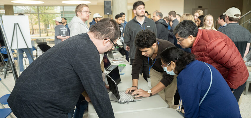 People intently view HackMT project