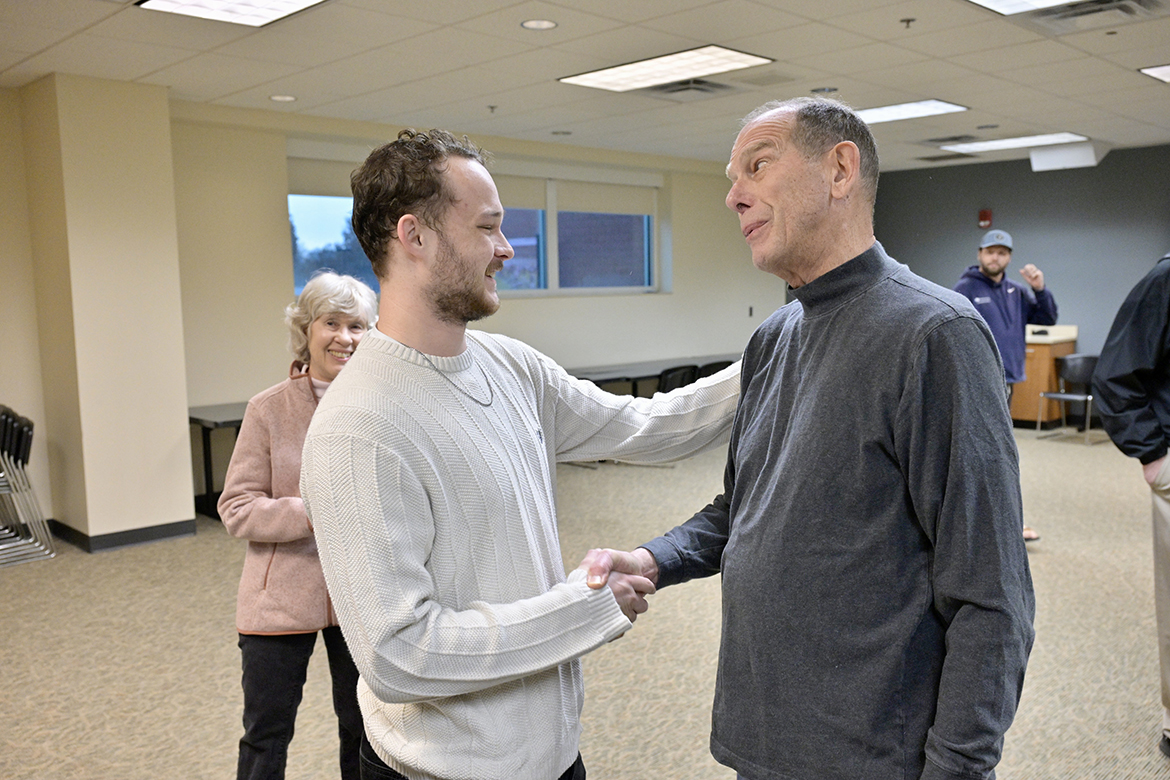 Retired Middle Tennessee State University professor and Computer Science Department Chair Richard Detmer, right, shakes hands and exchanges greetings with Gatlin Murr Friday, Feb. 9, in a second-floor Health, Wellness and Recreation Center conference room, as Detmer’s wife, Carol, watches. Murr was one of four MTSU student workers at the center who responded quickly when Richard Detmer had a cardiac arrest while playing racquetball. (MTSU photo by Andy Heidt)