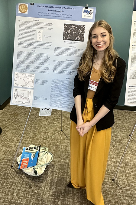 Sydney Robbins, a Middle Tennessee State University undergraduate student and researcher, takes a photo with her research presentation poster outlining her work studying a detection method for toxic insecticide at the annual Posters at the Capitol event held Feb. 14, 2024, at the state Capitol in Nashville, Tenn. (Submitted photo)