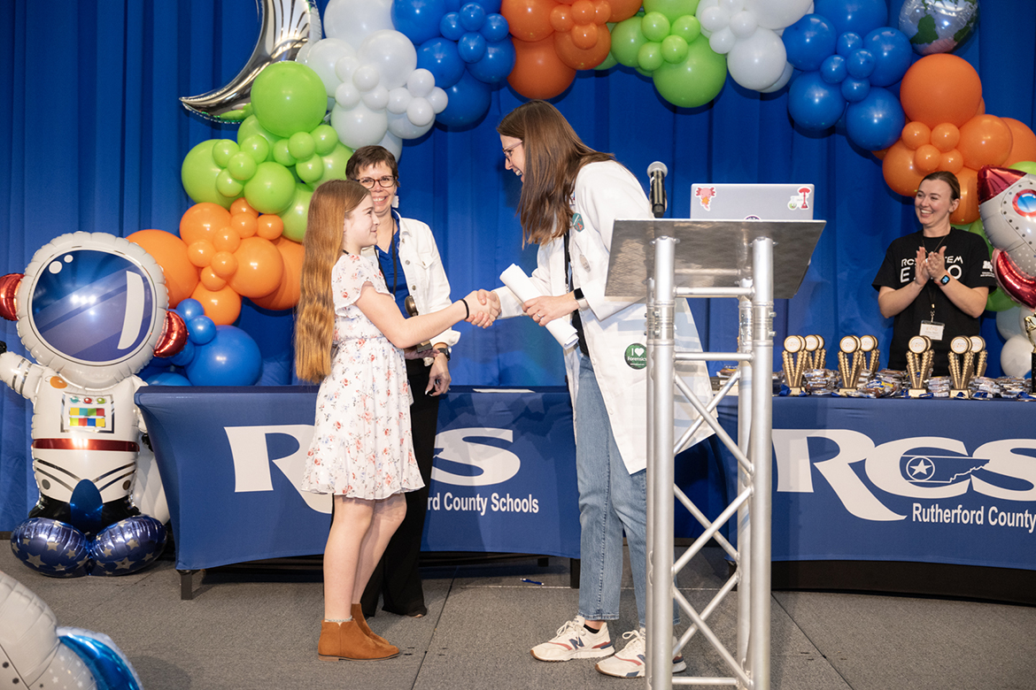 Stephanie Finley, right, Rutherford County Schools’ STEM specialist, congratulates a winner during the RCS STEM Fair, held Thursday, March 14, in the Middle Tennessee State University Student Union Ballroom in Murfreesboro, Tenn. Numerous awards were presented at the conclusion of the three-hour event where 400 students shared their science, technology, engineering and match research. (MTSU photo by James Cessna)