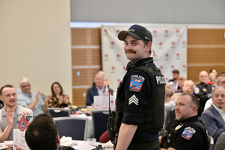 Middle Tennessee State University Police Sgt. Blake Durham, an emergency response trainer for the department, and Patrol Lt. Walter Spain, seated right in uniform, are recognized during the American Red Cross Heart of Tennessee Chapter’s “Heroes Luncheon” on March 5, 2024, for their lifesaving support to a cardiac arrest incident at the Campus Recreation Center. Durham attended on behalf of Master Police Officer Angela Todd, who responded the incident along with Spain. The luncheon was held at the Middle Tennessee State University Student Union Ballroom in Murfreesboro, Tenn. (MTSU photo by Andy Heidt) (MTSU photo by Andy Heidt)