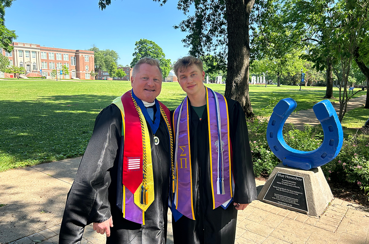 Shown here at Middle Tennessee State University’s Walnut Grove in their academic regalia, School of Journalism and Strategic Media instructor Dan Eschenfelder and his son Cameron graduated with their degrees one day apart during MTSU’s Spring 2024 commencement May 3-4. Dan earned his master’s in liberal arts and Cameron earned his bachelor’s in geosciences. (Photo courtesy of Dan Eschenfelder)
