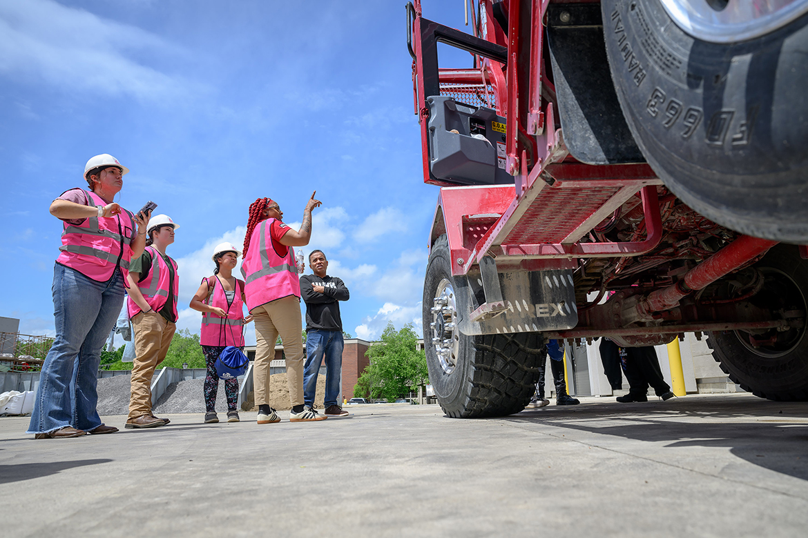 High school girls and a teacher attending the Middle Tennessee State University Concrete Industry Management Ladies in Concrete event at MTSU in Murfreesboro, Tenn., in early May await instructions from Gara “Gee” Harris, the Ready Mix truck driver working for Irving Materials Inc., on how to safely climb into the large IMI vehicle. A combined 220 middle and high school girls participated in seven stations during the four-hour event to showcase career opportunities available in the CIM program and industrywide. The event was sponsored by CIM Patrons. (MTSU photo by J. Intintoli)