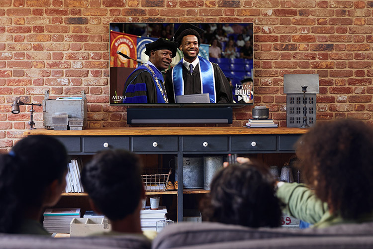 Sidney A. McPhee, president of Middle Tennessee State University, congratulates an MTSU graduate at a recent commencement ceremony at the Murphy Center in Murfreesboro, Tenn. True Blue TV allows individuals and families to access and watch live-streamed events from the MTSU campus in Murfreesboro, Tenn. (MTSU photo illustration)