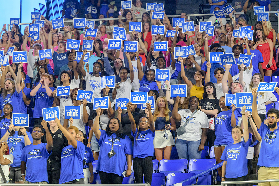 New Middle Tennessee State University freshmen and transfer students hold “I AM true BLUE” signs in the air moments after reciting the True Blue Pledge of core values in August 2024 during the 23rd University Convocation in Murphy Center in Murfreesboro, Tenn. Joined by family members, about 3,500 new freshmen and transfer students will be attending Convocation at 4 p.m. Saturday, Aug. 23. (MTSU file photo by J. Intintoli)
