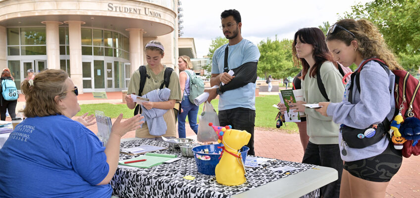 A representative from the Beesley Animal Foundation, left, speaks with Middle Tennessee State University students about volunteer opportunities during the fall Volunteer Fair held Tuesday, Oct. 1, near the Student Union Commons on the MTSU campus in Murfreesboro, Tenn. (MTSU photo by J. Intintoli)