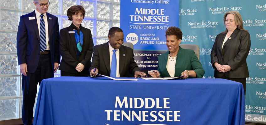 Middle Tennessee State University President Sidney A. McPhee, seated left, and Nashville State Community President Shanna L. Jackson, seated right, exchange documents during a signing ceremony held Tuesday, Jan. 28, at Miller Education Center on MTSU’s campus in Murfreesboro, Tenn. The two institutions signed agreements opening seamless pathways for Nashville State graduates earning an associate degree to transfer to MTSU to pursue bachelor’s degrees in either aerospace or cybersecurity management. Looking on, from left, are Greg Van Patten, dean of MTSU’s College of Basic and Applied Sciences, Nita Brooks, associate dean for the MTSU Jones College of Business, and, far right, Shawn Wild, dean of Nashville State’s School of Science, Technology, Engineering, and Mathematics. (MTSU photo by Andy Heidt)