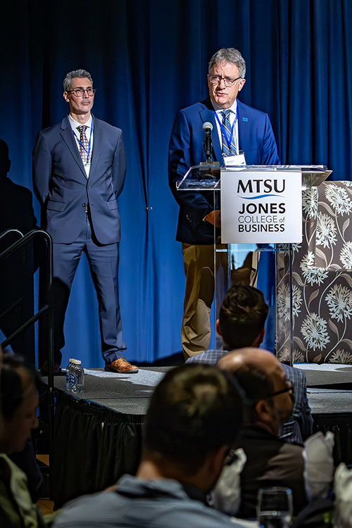Middle Tennessee State University Provost Mark Byrnes welcomes the audience Friday, March 21, during MTSU’s annual Forum on Growth and Regional Challenges inside the James Union Building Tennessee Ballroom on campus in Murfreesboro, Tenn. Behind him is forum moderator David Plazas of The Tennessean. (MTSU photo by Tom Beckwith)