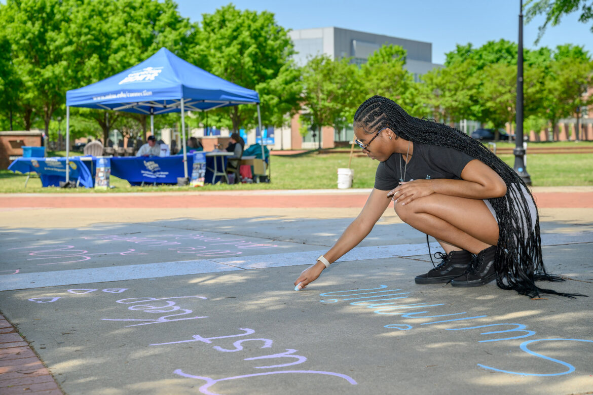 A student at Middle Tennessee State University in Murfreesboro, Tenn., uses chalk to decorate the sidewalk in front of the Student Union Building, 1768 MTSU Blvd., as part of the annual Color the Commons event that is part of the Sexual Assault Awareness Month activities spearheaded by the June Anderson Center for Women and Nontraditional Students. This year’s event will be happening in the same location from 10 a.m. to 2 p.m. Thursday, April 24. (Submitted photo)