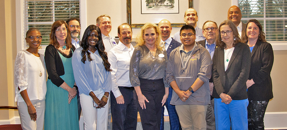 Rotary Club of Murfreesboro members join staff from Middle Tennessee State University’s Development Office for a group photo with Noon Rotary Club scholarship recipients Nyatuil Tongyik, front row, third from left, and Oscar Meza, front row, second from right, during the club’s special donor appreciation reception hosted recently at the Wood-Stegall Center on the MTSU campus. (MTSU photo by Brian Delaney)