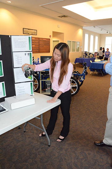 MTSU senior Van Trieu of Nashville views her "Cleaning Robot" senior project on display at the 2013 Engineering Technology Open House in Cantrell Hall of the Tom H. Jackson Building. For photos taken by engineering technology staff, visit http://tinyurl.com/ca3am8u. (Photo by MTSU News and Media Relations)