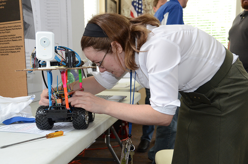 MTSU senior Whitley Rau of Lawrenceburg, Tenn., makes adjustments to her Wifi Enabled Toy Car just before the start of the annual Engineering Technology Open House May 2 in Cantrell Hall of the Tom H. Jackson Building. About 20 students showcased their senior research projects. Also on display were projects from the Experimental Vehicles Program. (Photo by MTSU News and Media Relations)