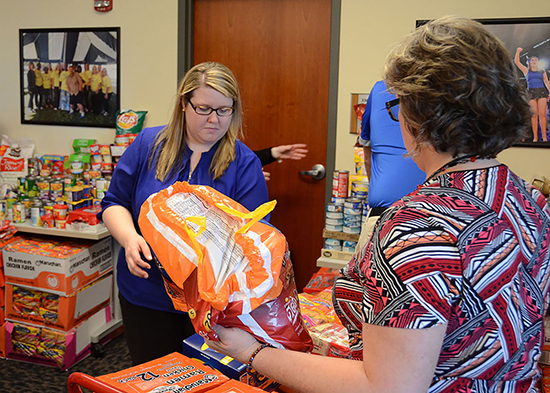 Kristen Russell, left, coordinator of outreach and support programs at MT One Stop, packs up donations collected recently by Fraternity and Sorority Life in support of the Student Food Pantry. Russell oversees pantry operations. Helping her is One Stop secretary Tina Chevalier. 