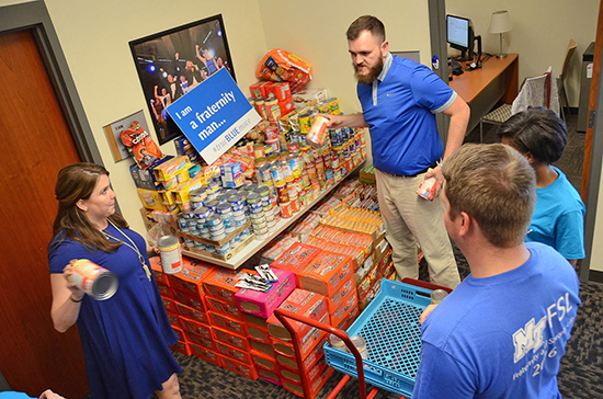 Members of MTSU’s Fraternity and Sorority Life sort donations stored inside the Student Union that were collected during a recent food drive in support of the Student Food Pantry. Pictured, from left to right, are FSL Director Leslie Merritt, FSL coordinator Zak Gosa-Lewis, Thomas Denney, Interfraternity Council president, and Jordan Gustus, National Panhellenic Council liaison. (MTSU photo by Jimmy Hart)