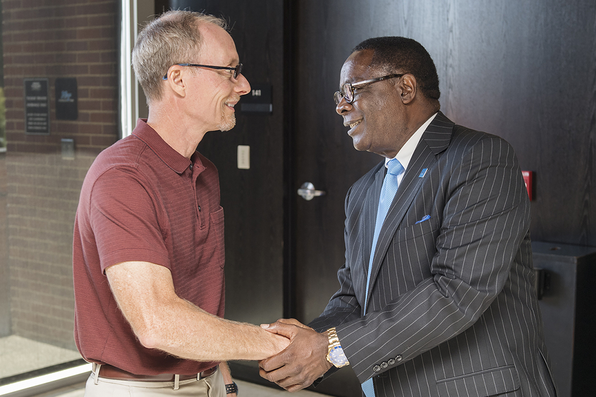 MTSU President Sidney A. McPhee, right, greets Ron Henderson, chair of the Department of Physics and Astronomy, before McPhee’s State of the University address Thursday, Aug. 24, at the annual Fall Faculty Meeting inside Tucker Theatre. (MTSU photo by Andy Heidt)