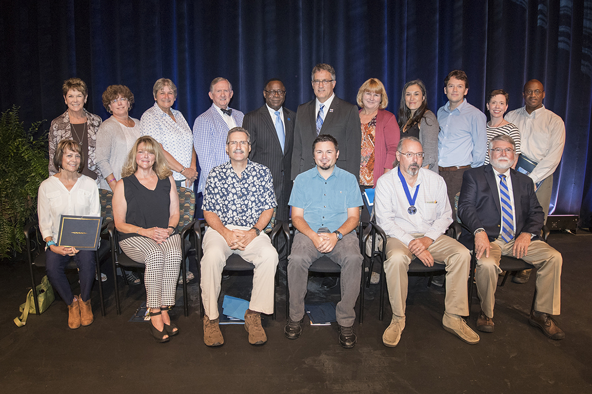MTSU faculty members gather for a group photo with university leaders Thursday, Aug. 24, after they were recognized by the MTSU Foundation for their service at the Fall Faculty Meeting inside Tucker Theatre. The 15 recipients and their 2017 honors include, front row from left, Becky B. Alexander, Outstanding Achievement in Instructional Technology Award; K. Virginia Hemby, Outstanding Public Service Award; Timothy R. “Tim” Graeff, Outstanding Teacher Award; Tyler A. Babb, Outstanding Achievement in Instructional Technology Award; Kevin E. Smith, Career Achievement Award; Hugh E. Berryman, Special Projects Award. Standing in the back row are, from left, Virginia S. “Ginny” Danby, Outstanding Teacher Award; Mary B. Farone, Distinguished Research Award; Nancy Ruth James, Outstanding Public Service Award; MTSU alumnus Ron Nichols, who is vice president of the MTSU Foundation; MTSU President Sidney A. McPhee; Janet K. McCormick, Outstanding Teacher Award; Rebekka King, Outstanding Teacher Award; Seth J. Marshall, Outstanding Teacher Award; Julie A. Myatt Barger, Outstanding Teaching in General Education; and Sekou M. Franklin, Outstanding Public Service Award. Not pictured is Charles O. “Odie” Blackman, Creative Activity Award. (MTSU photo by Andy Heidt)