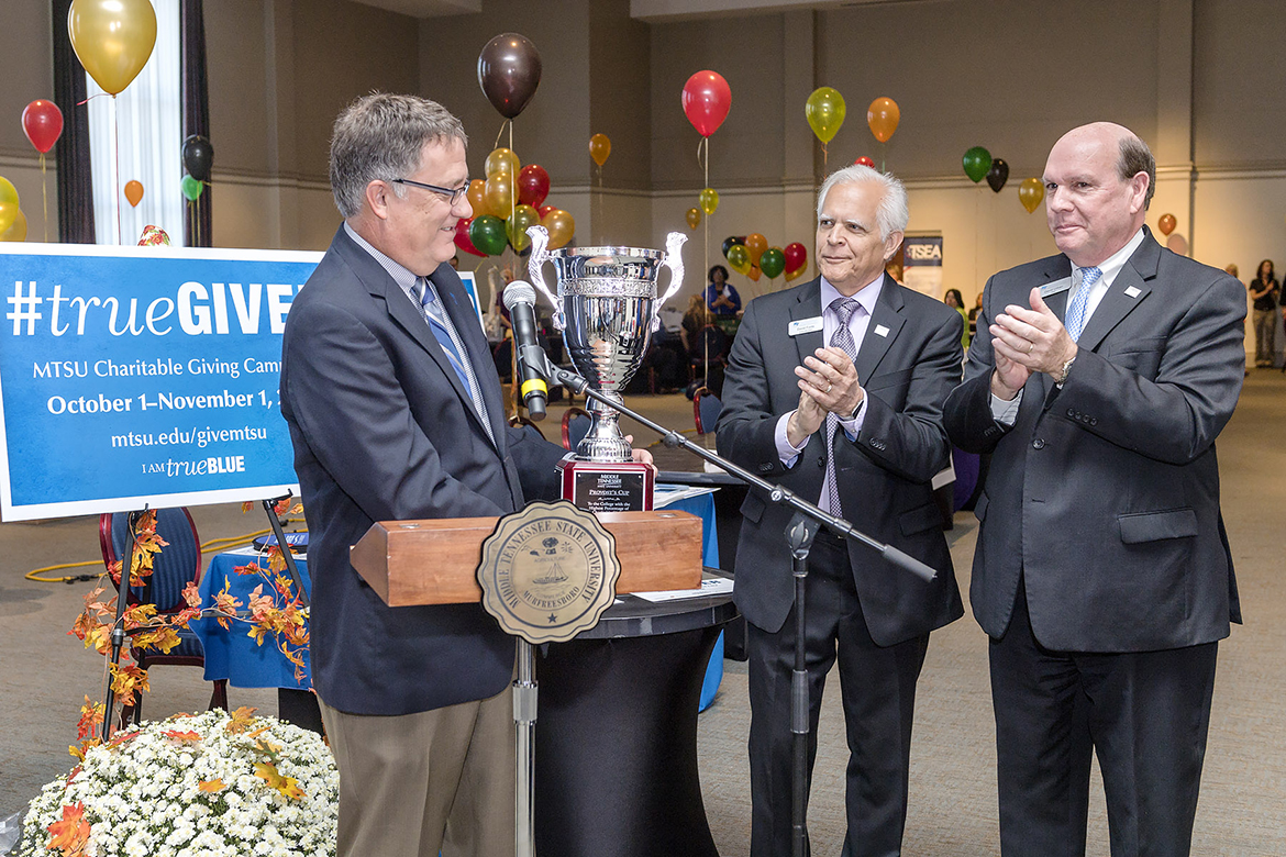 From left, MTSU University Provost Mark Byrnes accepts return of the Provost's Cup from David Foote, associate dean of the Jennings A. Jones College of Business, and David Urban, dean of Jones College, during the 2017 MTSU Charitable Giving Campaign Kickoff held Wednesday, Sept. 27, inside the James Union Building. The Provost Cup is presented each year to the academic college with the highest percentage of givers. Jones College has won the cup for year in a row. (MTSU photo by J. Intintoli)