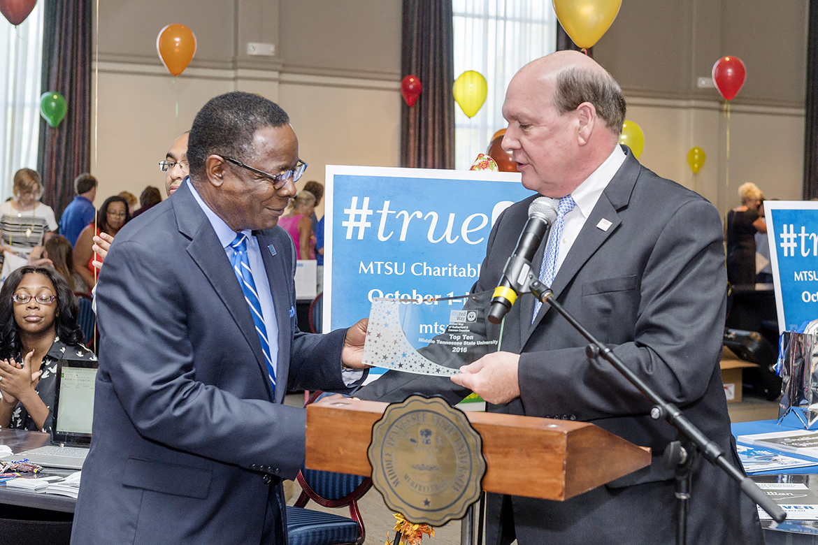 David Urban, right, dean of the Jennings A. Jones College of Business, presents MTSU President Sidney A. McPhee with a 2016 Top 10 Award from United Way of Rutherford and Cannon Counties during the 2017 MTSU Charitable Giving Campaign Kickoff held Wednesday, Sept. 27, in the James Union Building. (MTSU photo by J. Intintoli)