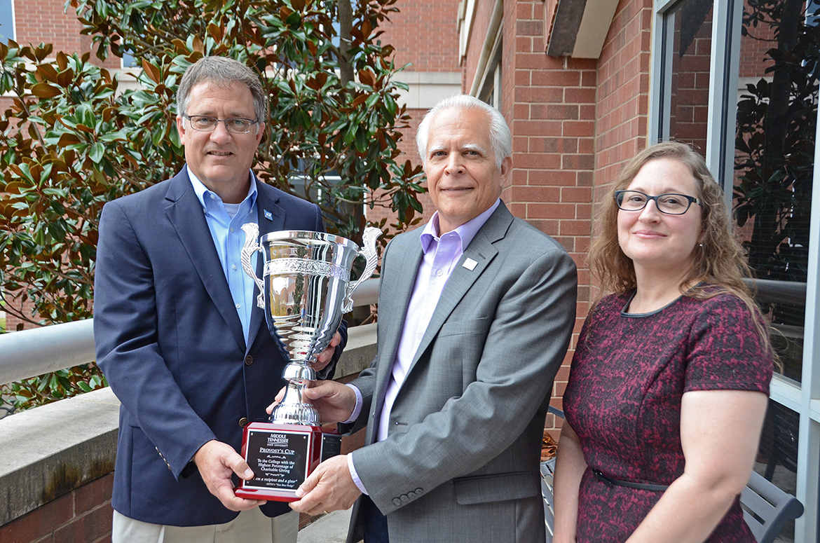 University Provost Mark Byrnes, left, presents the Provost Cup to the Jennings A. Jones College Business for having the highest percentage giving among academic units for the fifth straight year as part of the Employee Charitable Giving Campaign. Accepting on behalf of the Jones College is Associate Dean David Foote, center, and Teena Young, campaign chair for the college and graduation analyst in the undergraduate advising center. (MTSU photo by Jimmy Hart)