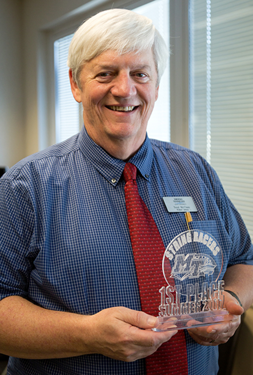 Neal McClain, director of library technology at MTSU's James E. Walker Library, holds the first-place award for winning the summer prototype String Race at the library’s Makerspace. The first official race is slated for Tuesday, Oct. 24. (Photo courtesy of James E. Walker Library)