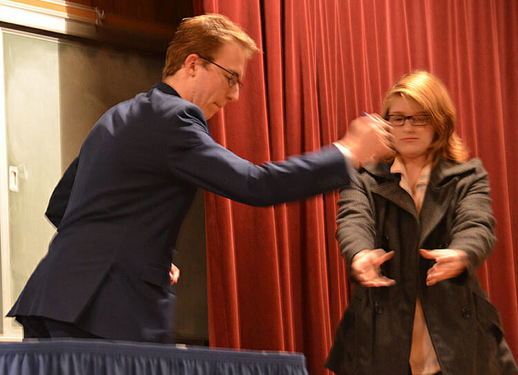 With the help of a somewhat wary assistant from the audience, MTSU sophomore Austin Ford, left, performs a magic trick during his free magic show held Nov. 16 in the Keathley University Center Theater. (MTSU photo by Jayla Jackson)