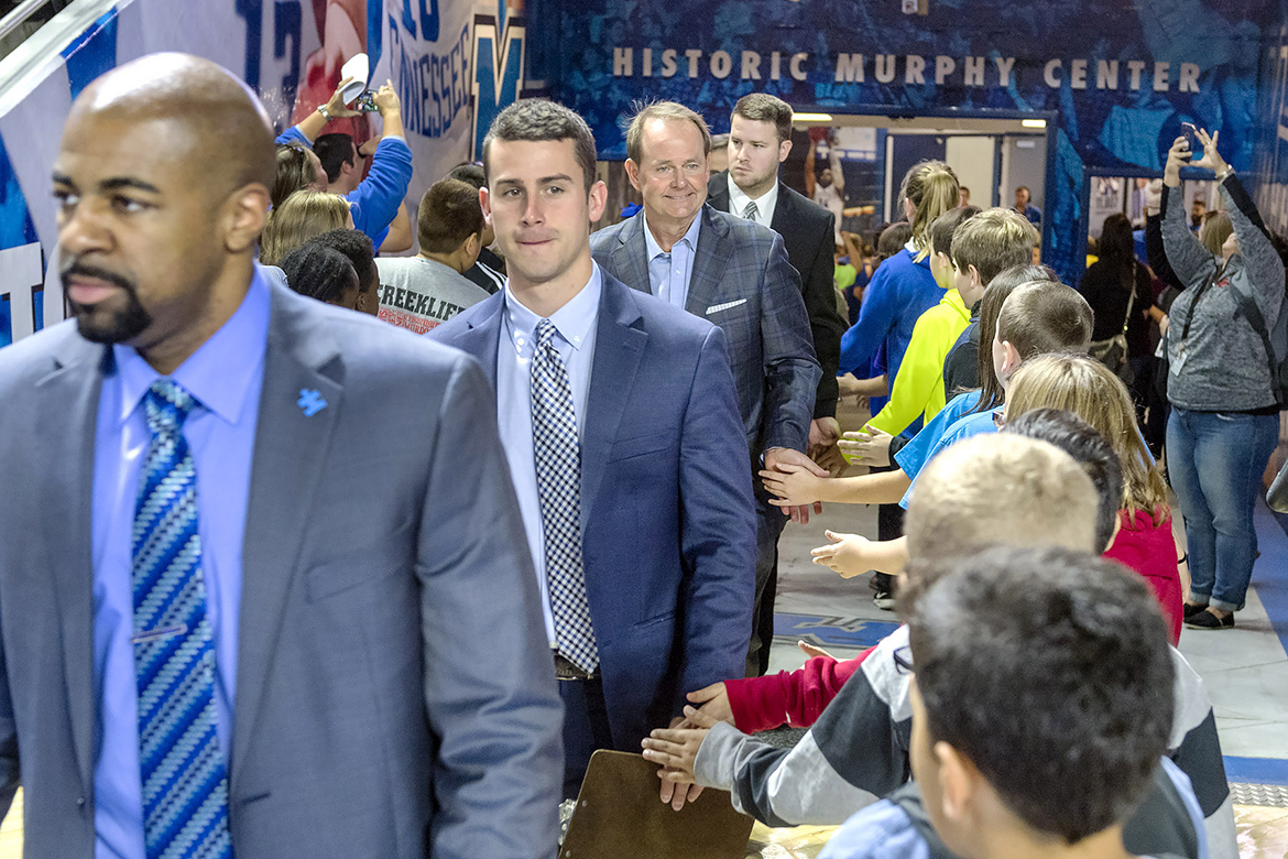 Rutherford County Schools' students high five Middle Tennessee men's basketball coaches.