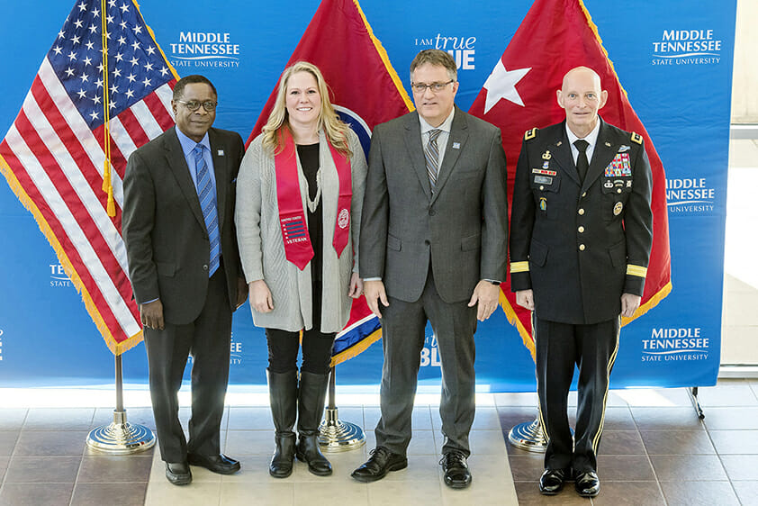MTSU President Sidney A. McPhee, left, student veteran Sara Russell, Provost Mark Byrnes and Keith M. Huber, MTSU senior adviser for veterans and leadership initiatives, celebrate after presenting Russell with the red stole that she and other student veterans will wear during the university’s Dec. 16 graduation ceremonies. (MTSU photo by J. Intintoli)