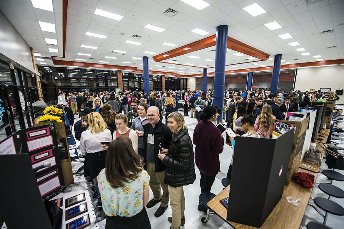 A large crowd makes the rounds of student research projects on display during the Feb. 8 Blackman Collegiate Academy Capstone Gallery Walk in the Blackman High School cafeteria. (MTSU photo by Eric Sutton)