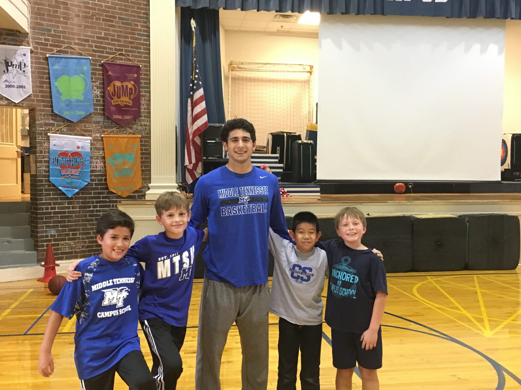 Chase Miller posing for a picture with kids.