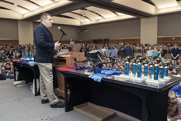 Doug Campbell, Unmanned Aircraft Systems operations manager for MTSU's Department of Aerospace, explains to youngsters attending MTSU's 26th annual Invention Convention how the drones used today began more than a century ago as a bright idea - just like one of their inventions. More than 800 fourth-, fifth- and sixth-graders participated in the event in MTSU's Student Union Ballroom. (MTSU photo by Andy Heidt)