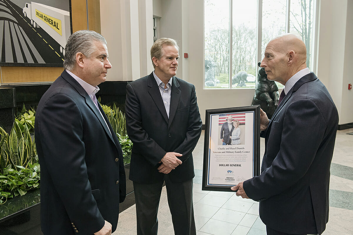 Dollar General executives Todd Vasos and Bob Ravener visit with MTSU's Keith M. Huber.